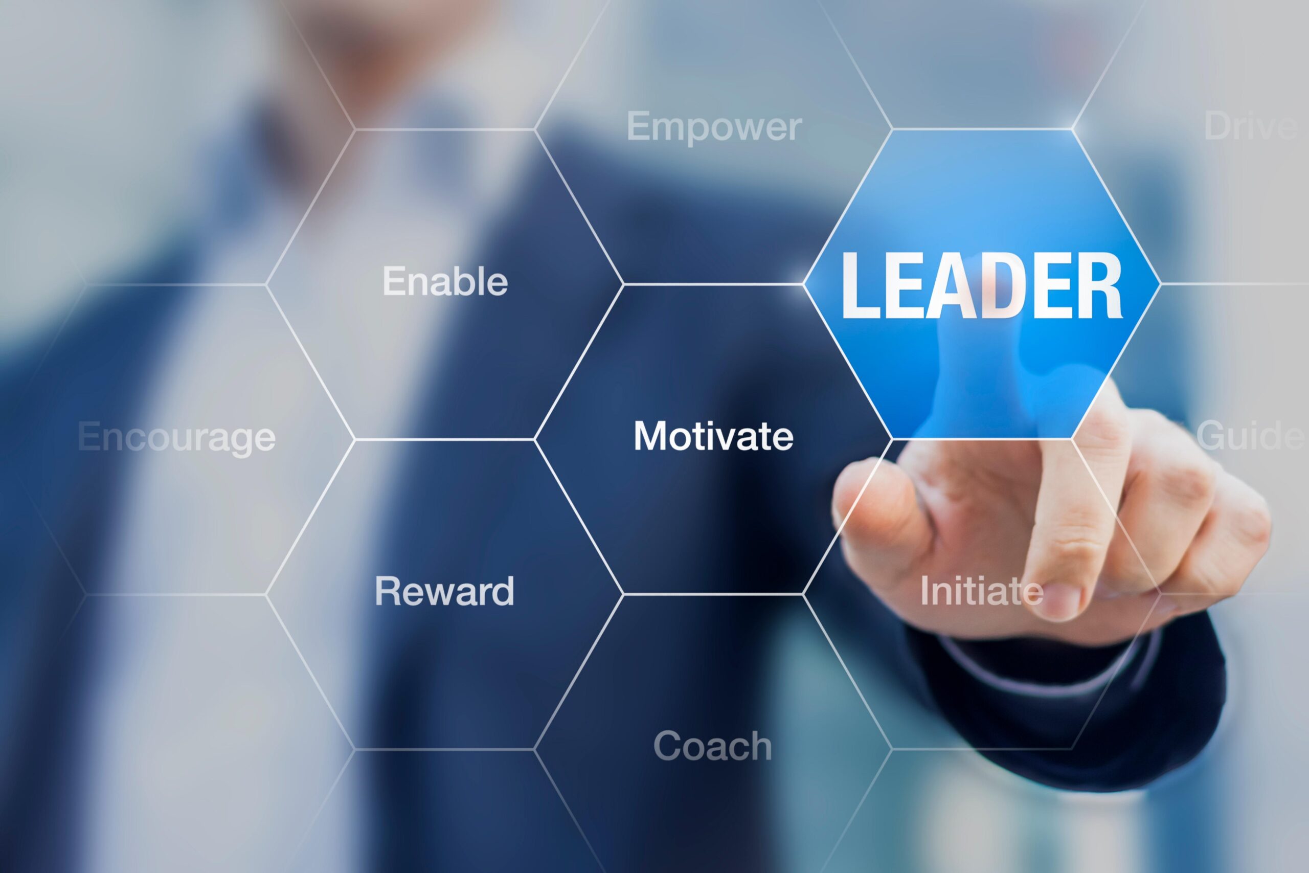 man is pointing blue button that says leadership scaled